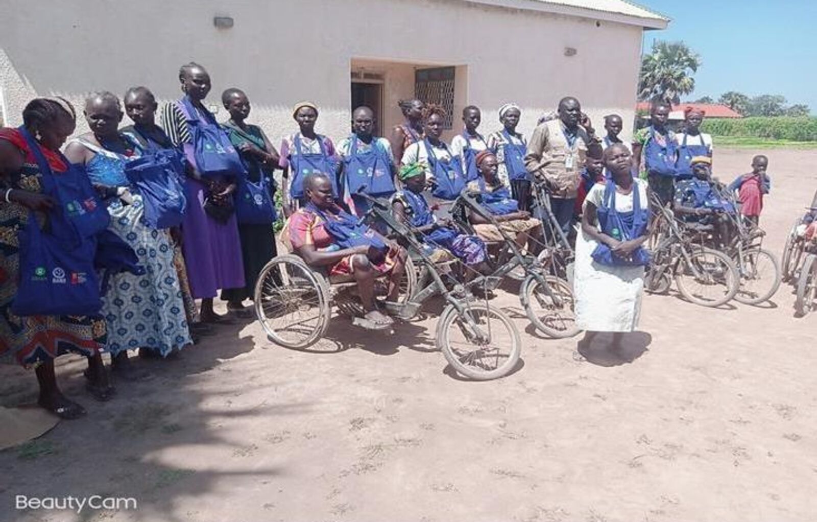 Community members with disabilities in Rumbek with mobility aids and dignity kits provided by DARD