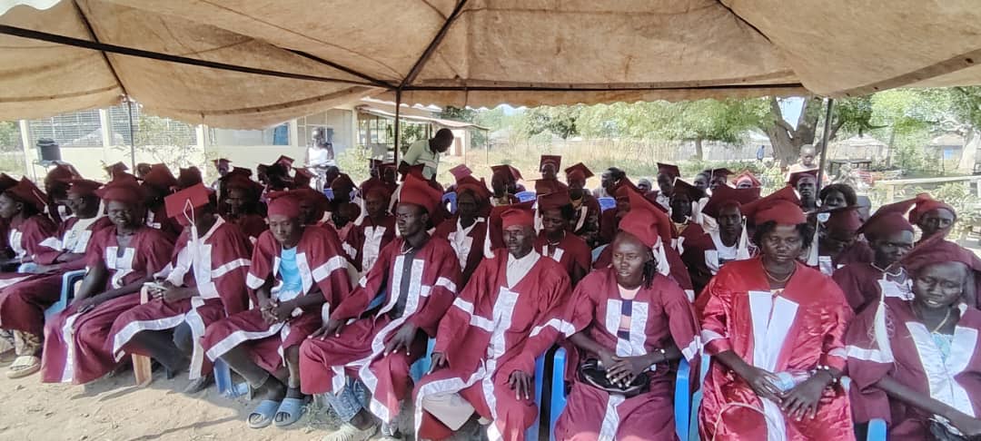 Graduates in academic gowns at an inclusive education and skills development ceremony
