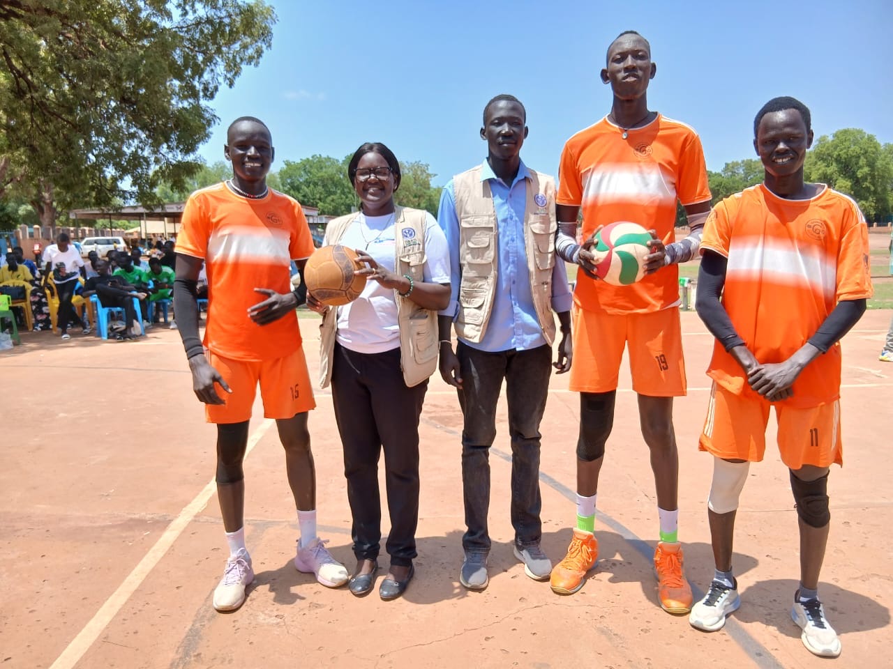 DARD staff with volleyball players during a community sports event